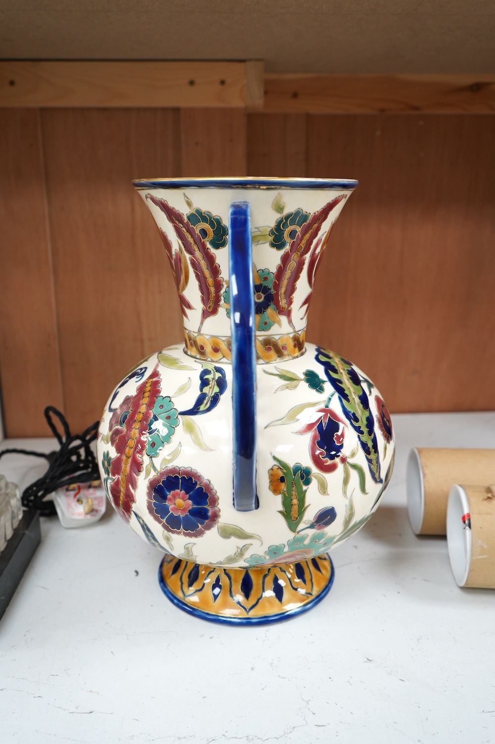 A large Hungarian Zsolnay two handled floral vase, 32cm high. Condition - fair, minor restoration